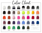 a color chart with various colored beanie hats, each corresponding to a different color. The chart includes a variety of colors such as white, grey, black, navy, grey & navy, black & dark grey, charcoal, and camo. The colors are organized in rows and columns, with each row representing a different color and each column representing a different type of beanie hat. The chart provides a visual representation of the different color combinations and styles available for beanie hats.